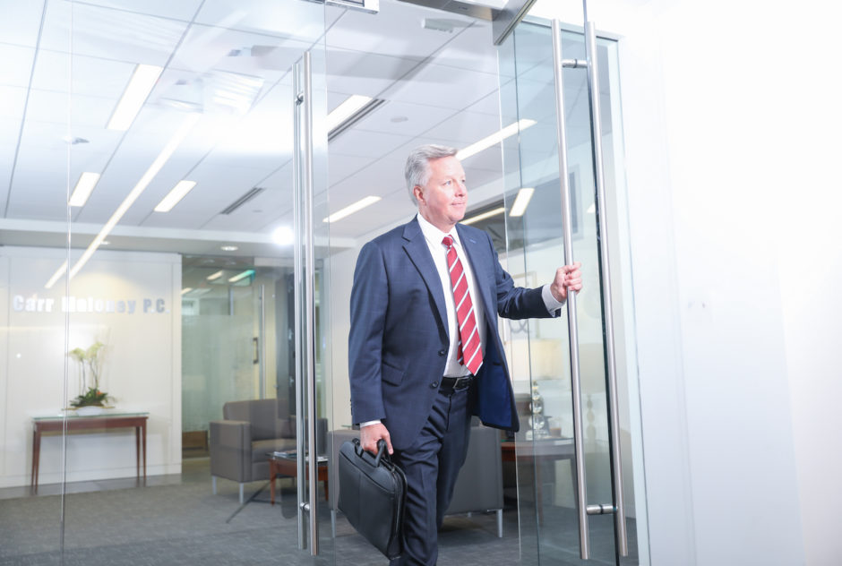 Thomas McCally leaving the Carr Maloney offices.