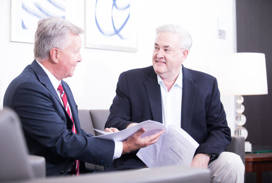 Attorneys McCally and Stallard discussing a document.