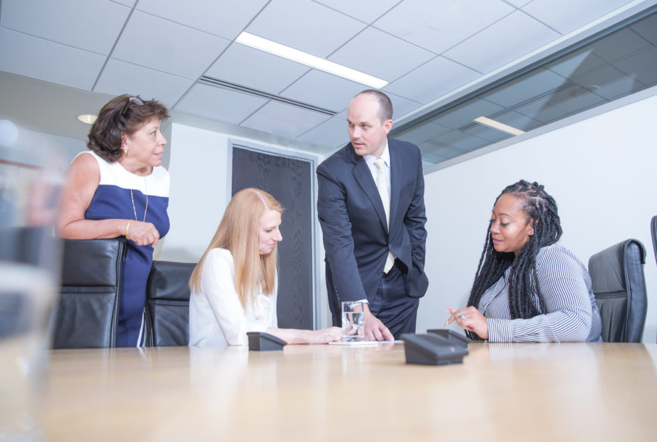 A group of the Carr Maloney attorneys working together with staff members on a case.