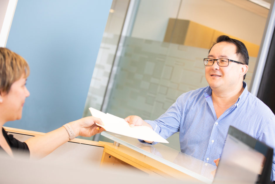 Attorney Dennis Chong handling documents.