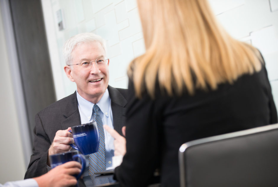 Attorney Paul J. Maloney holding a Carr Maloney coffee mug