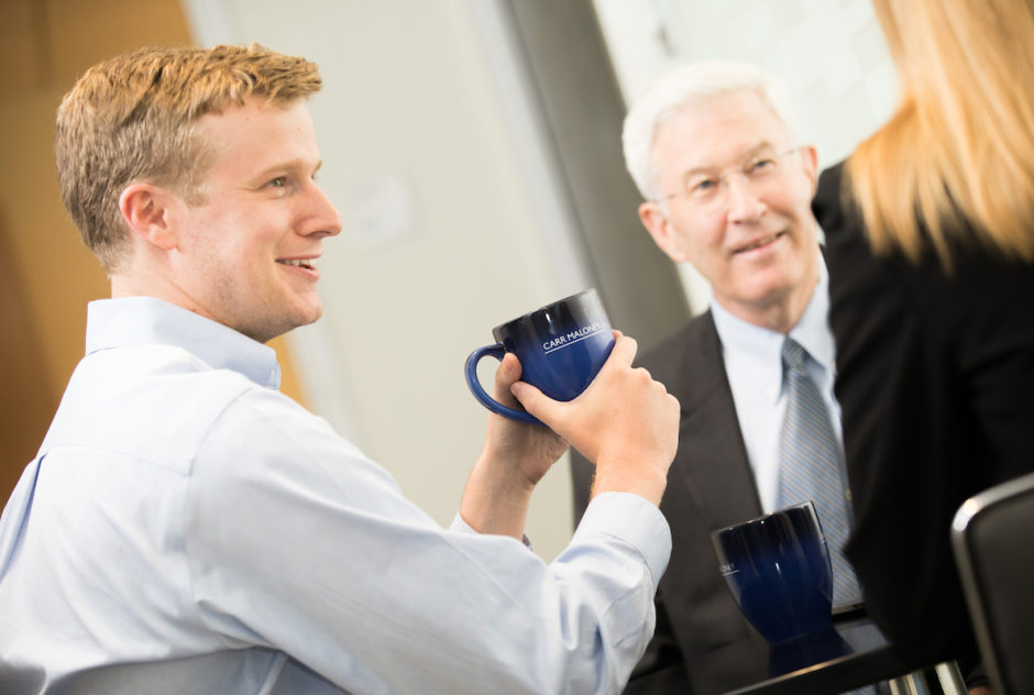 Attorneys Charles Frye and Paul Maloney chatting over coffee.